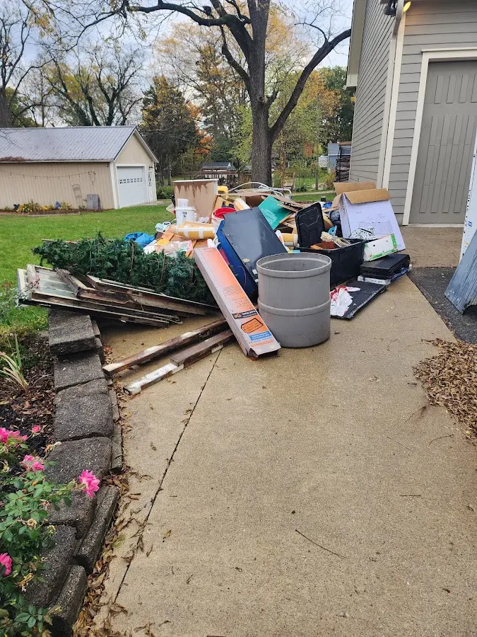 Dumpster being loaded with debris for Commercial Dumpster Rental in Ferndale